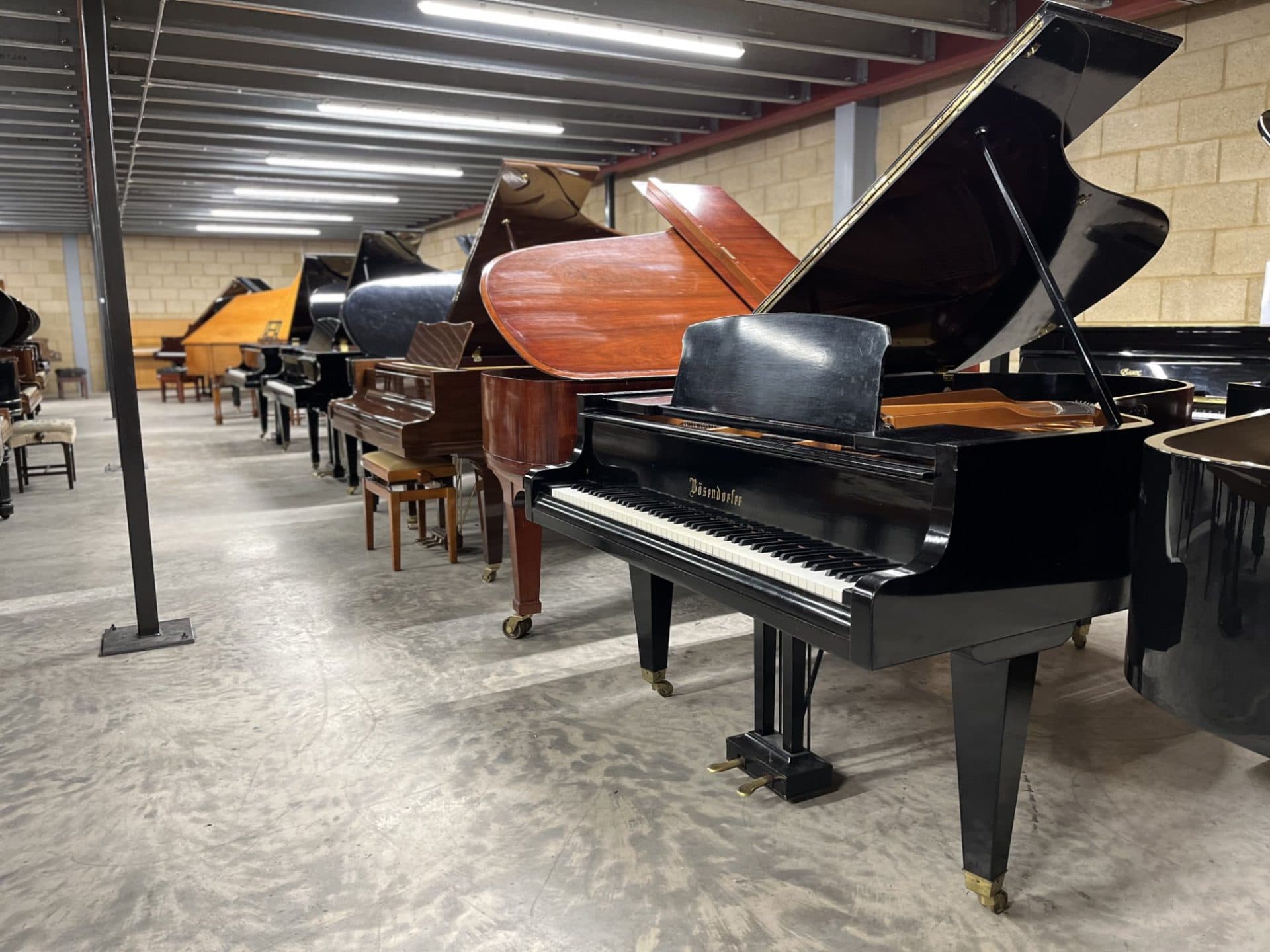 Pianos on the saleroom floor at Watford