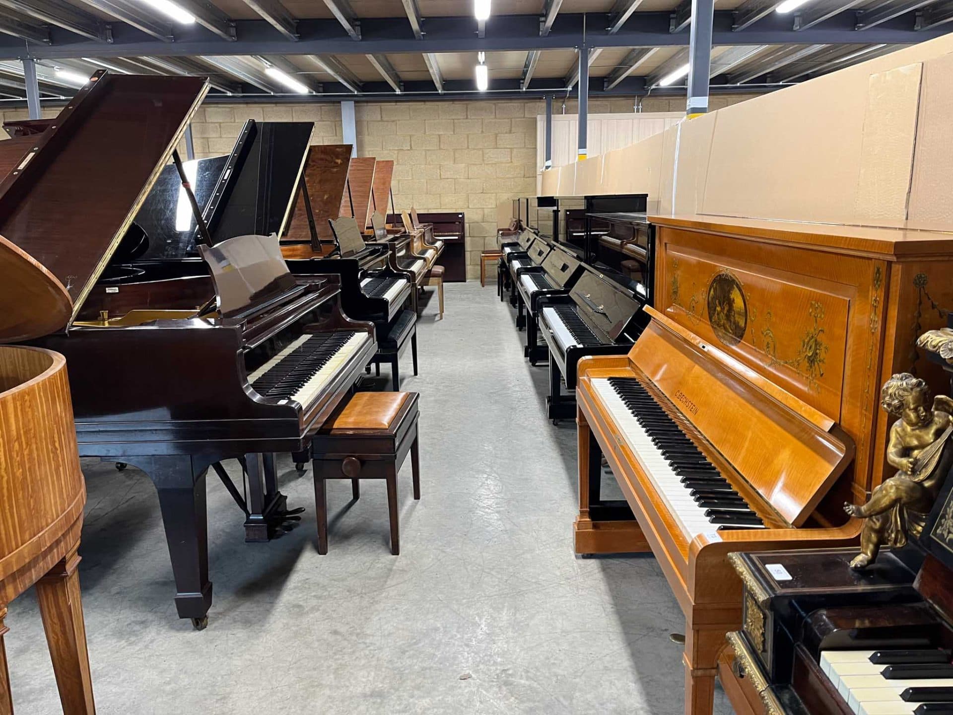 Grand pianos lined up at the Piano Auctions Ltd warehouse