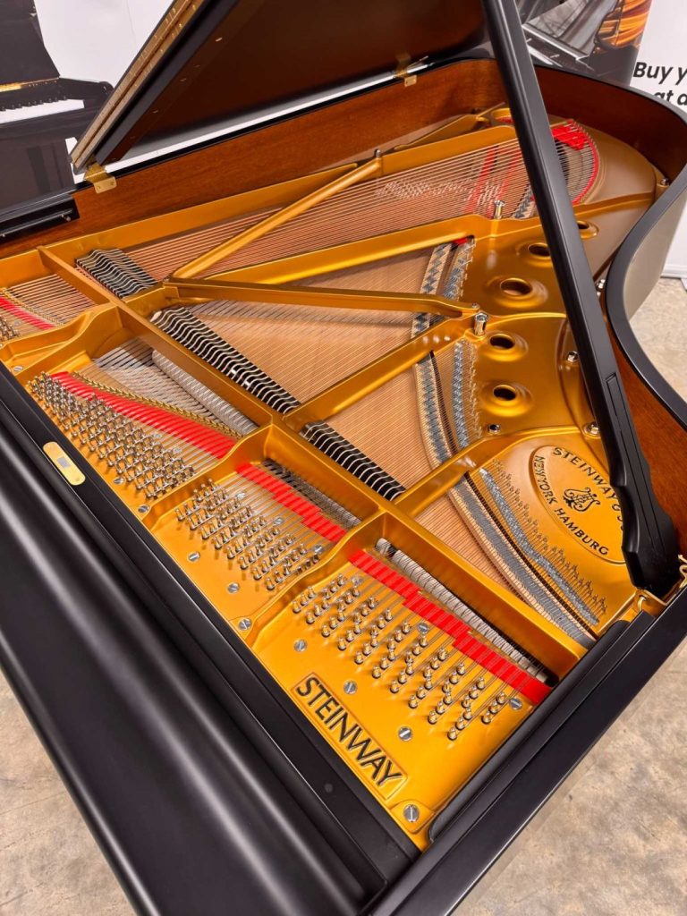 Steinway Model B grand piano tuning pins and soundboard. Available to buy at piano auctions.
